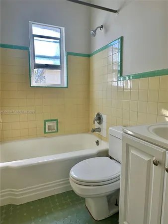 a bathroom with a toilet a sink and bathtub