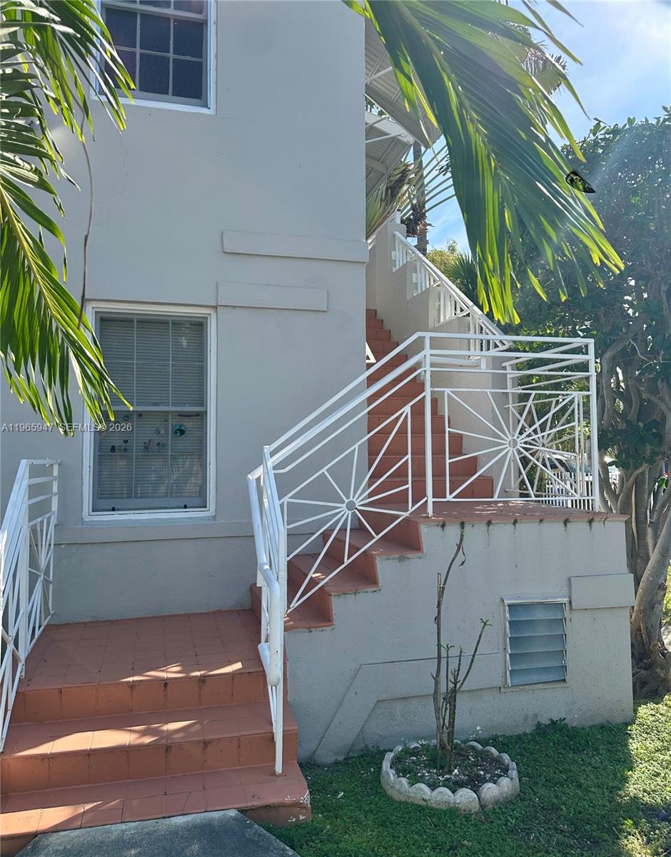 430 76th Street, Unit 4 Miami Beach, FL 33141 - Photo 22 of 24 a backyard of a house with lots of green space and fountain