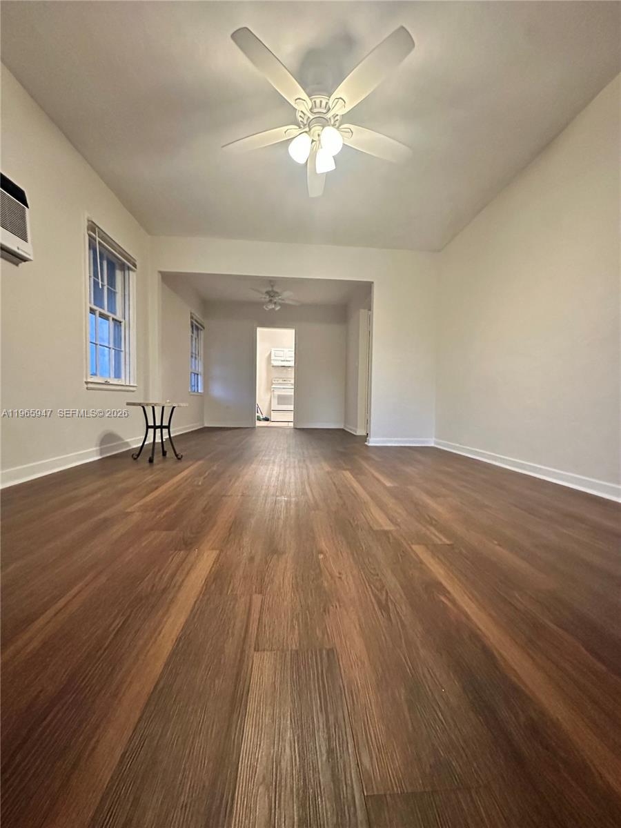 430 76th Street, Unit 4 Miami Beach, FL 33141 - Photo 3 of 24 a view of a room with wooden floor and a ceiling fan
