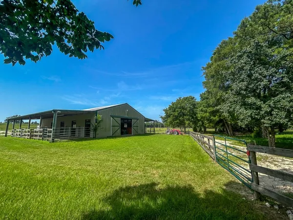 a view of a house with a yard and a garden