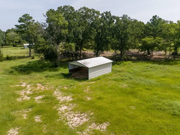 a view of a backyard with swimming pool