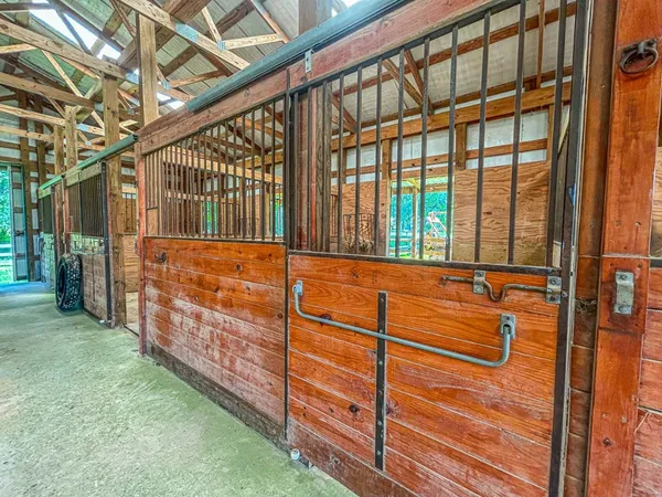 a view of a porch with wooden floor and iron stairs