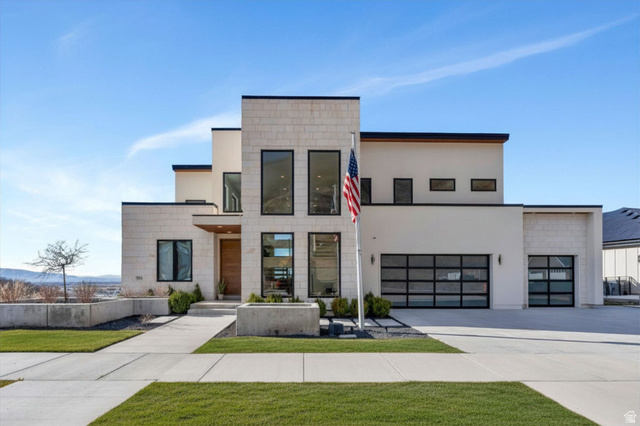 3918 South Mapleton Ests Drive Mapleton, UT 84664 - Photo 1 of 103 Modern home with concrete driveway, a front lawn, stucco siding, and an attached garage