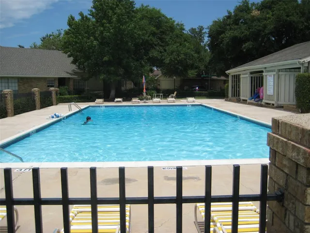 swimming pool view with a seating space