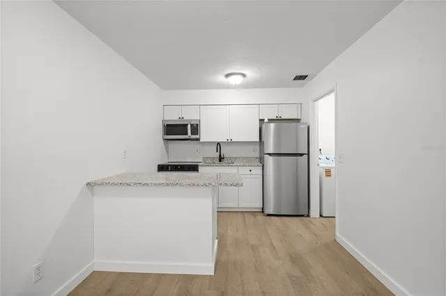 a kitchen with a sink and cabinets