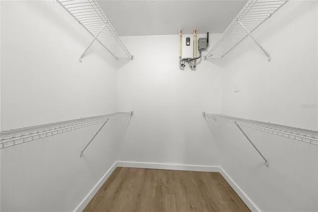 a view of a kitchen with a sink and wooden floor