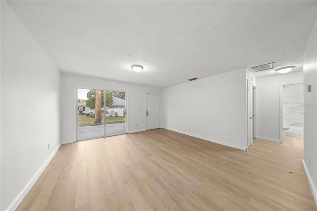 a view of a livingroom with a ceiling fan and window
