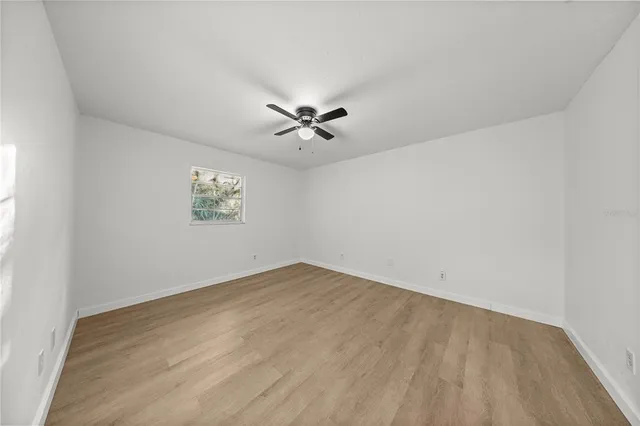 a view of an empty room with wooden floor