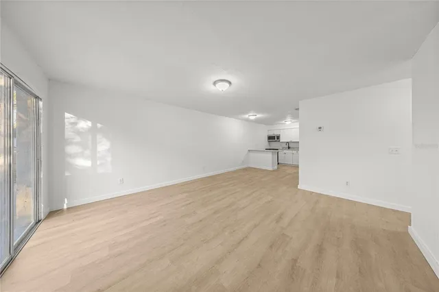 a view of a kitchen with a sink and a refrigerator