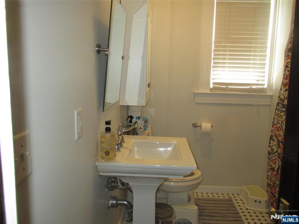 23 Highland Cross, Unit 1 Rutherford, NJ 07070 - Photo 9 of 11 a bathroom with a sink and a toilet