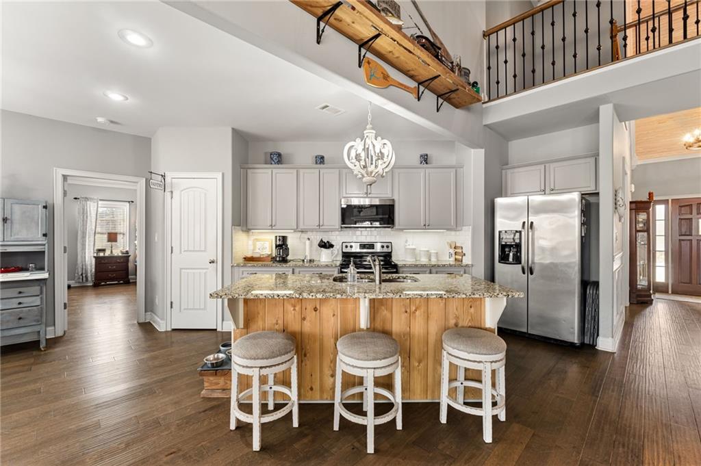 150 Crestview Road Jackson, GA 30233 - Photo 37 of 88 a kitchen with stainless steel appliances granite countertop a dining table chairs refrigerator and microwave