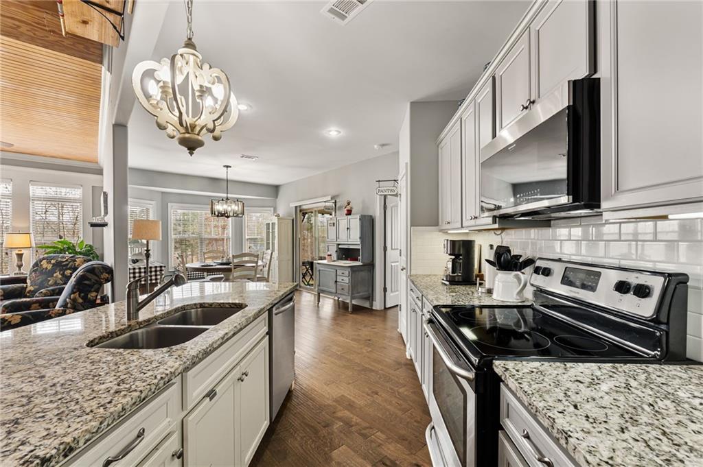 150 Crestview Road Jackson, GA 30233 - Photo 39 of 88 a kitchen with stainless steel appliances granite countertop a sink stove and refrigerator