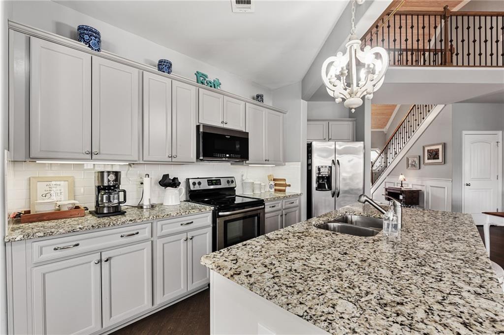 150 Crestview Road Jackson, GA 30233 - Photo 40 of 88 a kitchen with stainless steel appliances kitchen island granite countertop a sink dishwasher stove top oven and cabinets