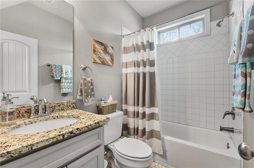 150 Crestview Road Jackson, GA 30233 - Photo 56 of 88 a bathroom with a granite countertop sink toilet mirror and bathtub