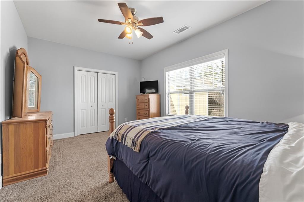 150 Crestview Road Jackson, GA 30233 - Photo 68 of 88 a bedroom with a large bed and a chandelier