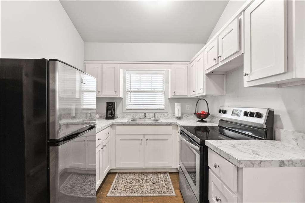 150 Crestview Road Jackson, GA 30233 - Photo 76 of 88 a kitchen with a sink a refrigerator and cabinets