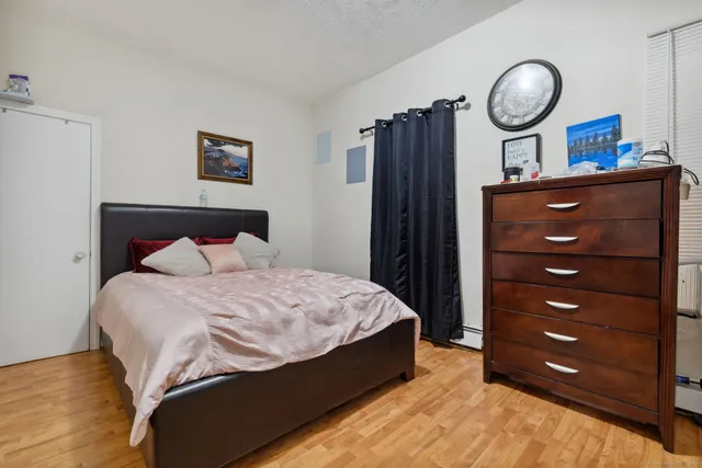 a large bed sitting in a bedroom and a mirror