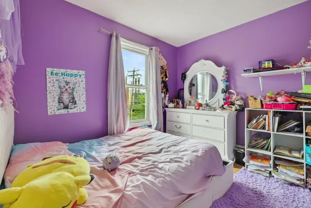 a bedroom with a bed and a mirror