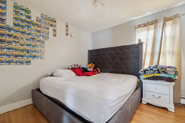 a bedroom with a bed and a dresser