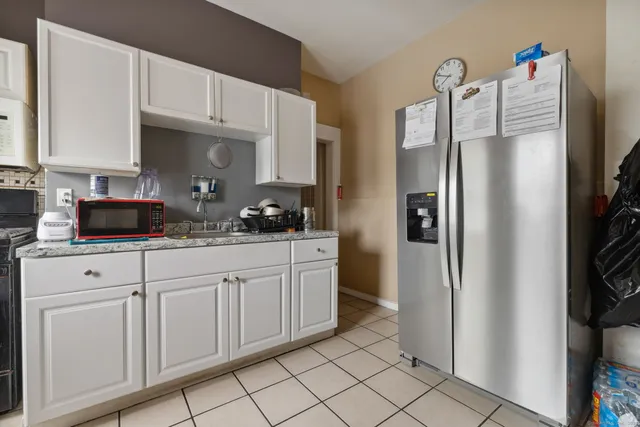 a kitchen with stainless steel appliances a refrigerator sink and cabinets