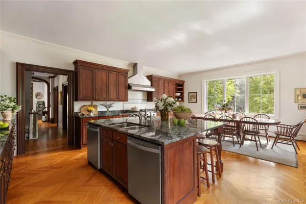 a kitchen with granite countertop a stove and a view of living room