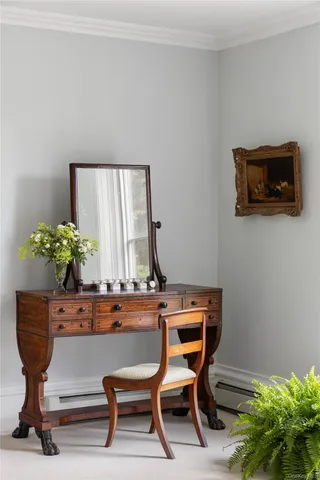 a room with a table chairs and a potted plant