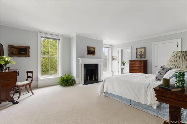 a bedroom with a bed and a fireplace