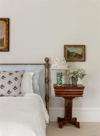 a bedroom with a bed and paintings on the wall