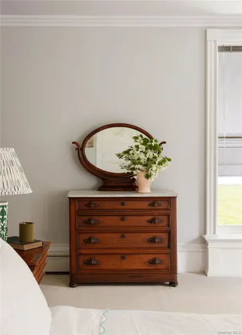 a view of room with furniture and a dresser