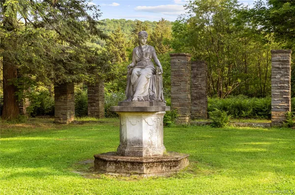 a view of a fountain in a yard with palm trees