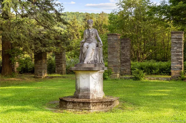 a view of a fountain in a yard with palm trees