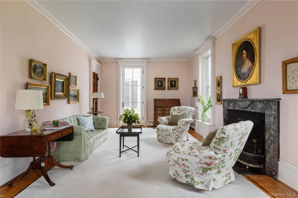 a living room with furniture a rug and a fireplace