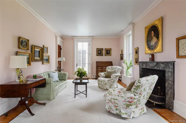 a living room with furniture a rug and a fireplace