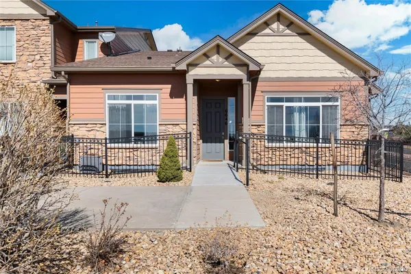 a view of a house with wooden fence and large windows