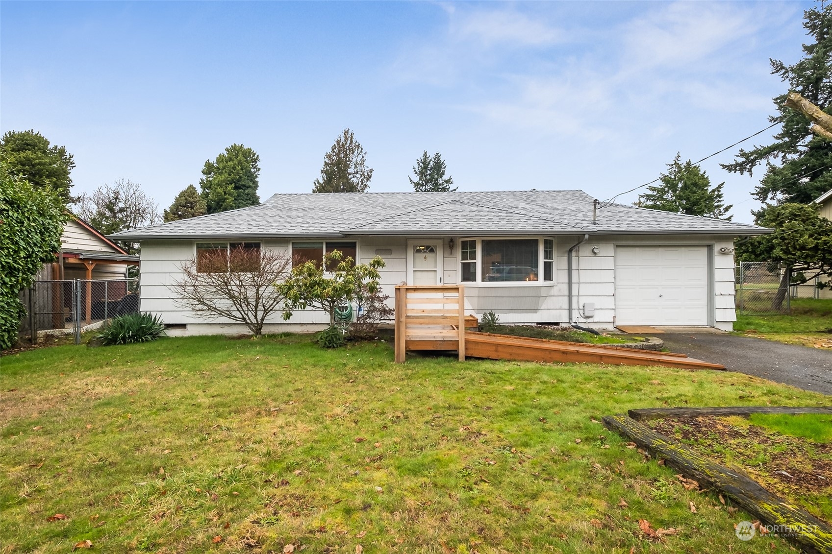 10810 Southeast 182nd Street Renton, WA 98055 - Photo 1 of 24 a front view of a house with a garden and trees
