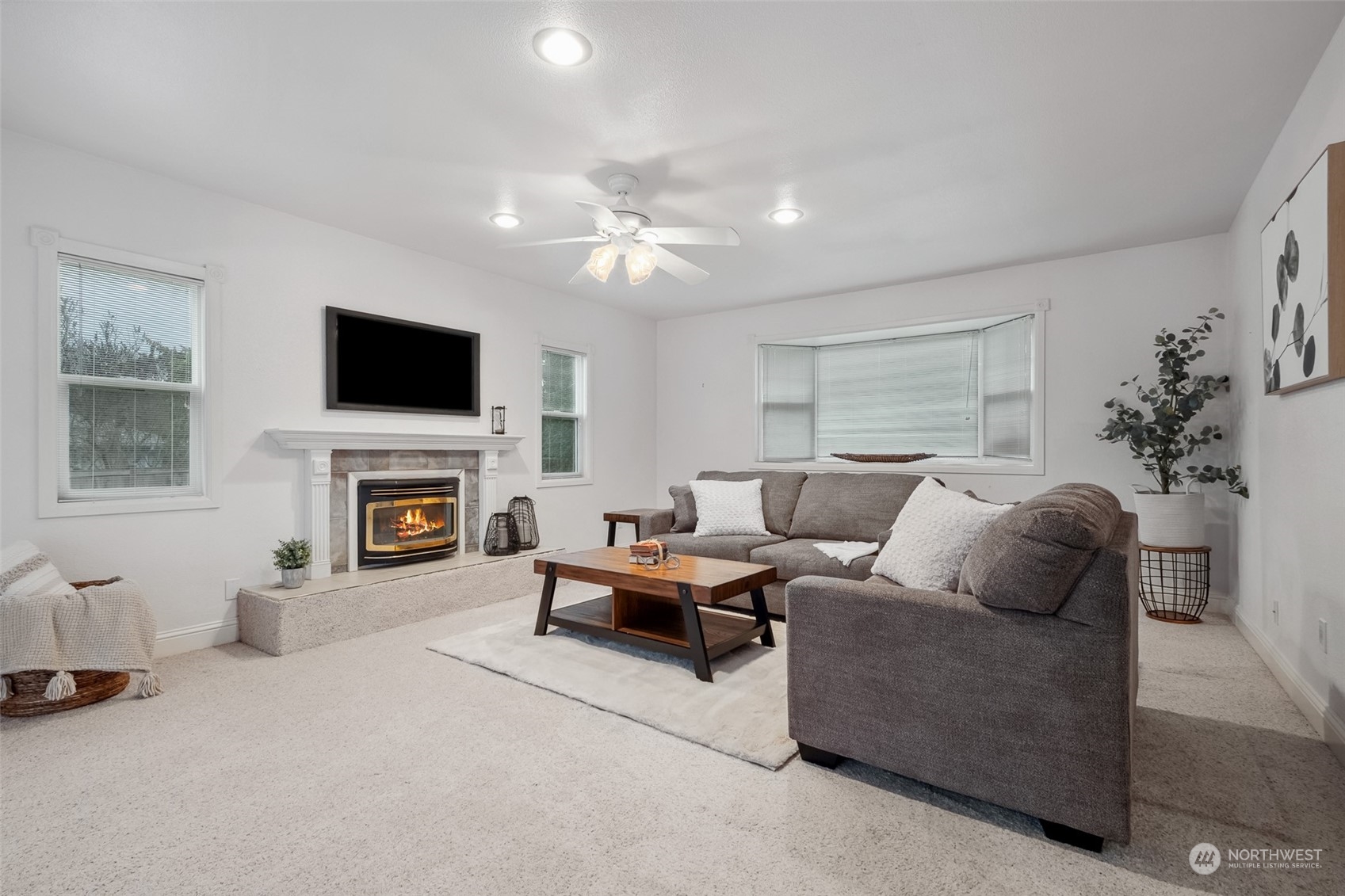 10810 Southeast 182nd Street Renton, WA 98055 - Photo 11 of 24 a living room with furniture a fireplace and a flat screen tv