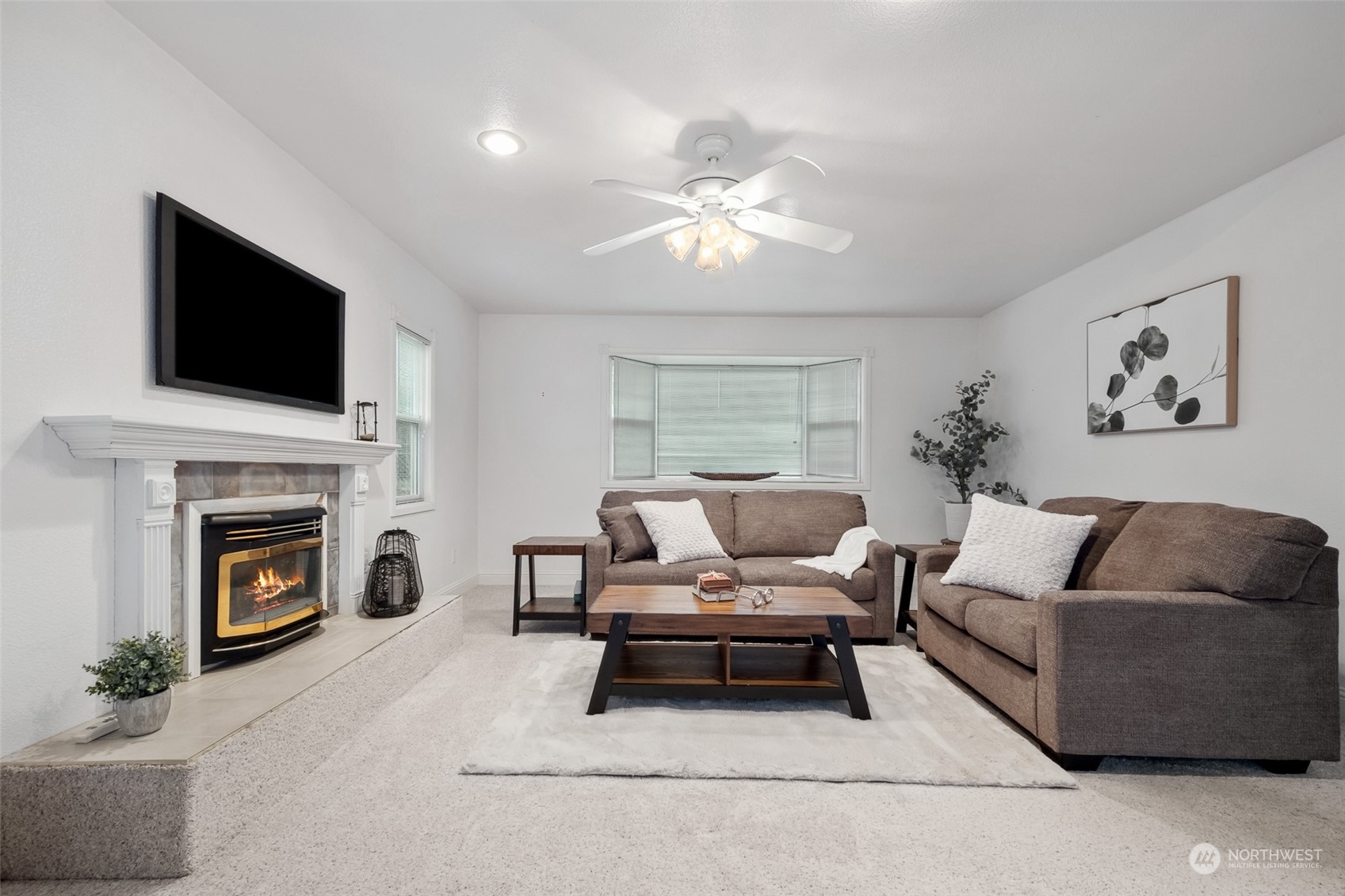 10810 Southeast 182nd Street Renton, WA 98055 - Photo 12 of 24 a living room with furniture a fireplace and a flat screen tv