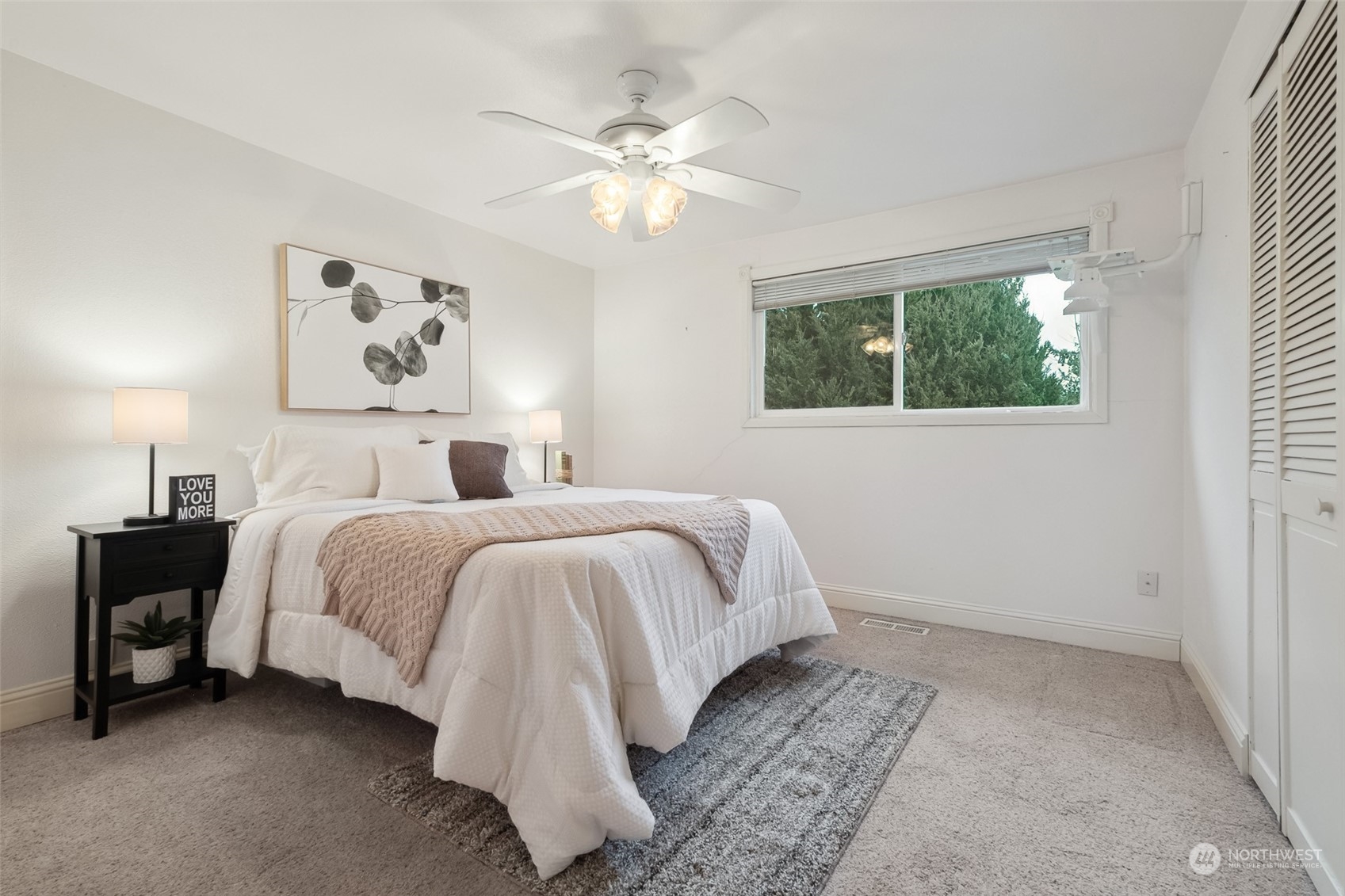10810 Southeast 182nd Street Renton, WA 98055 - Photo 15 of 24 a spacious bedroom with a bed and a chandelier