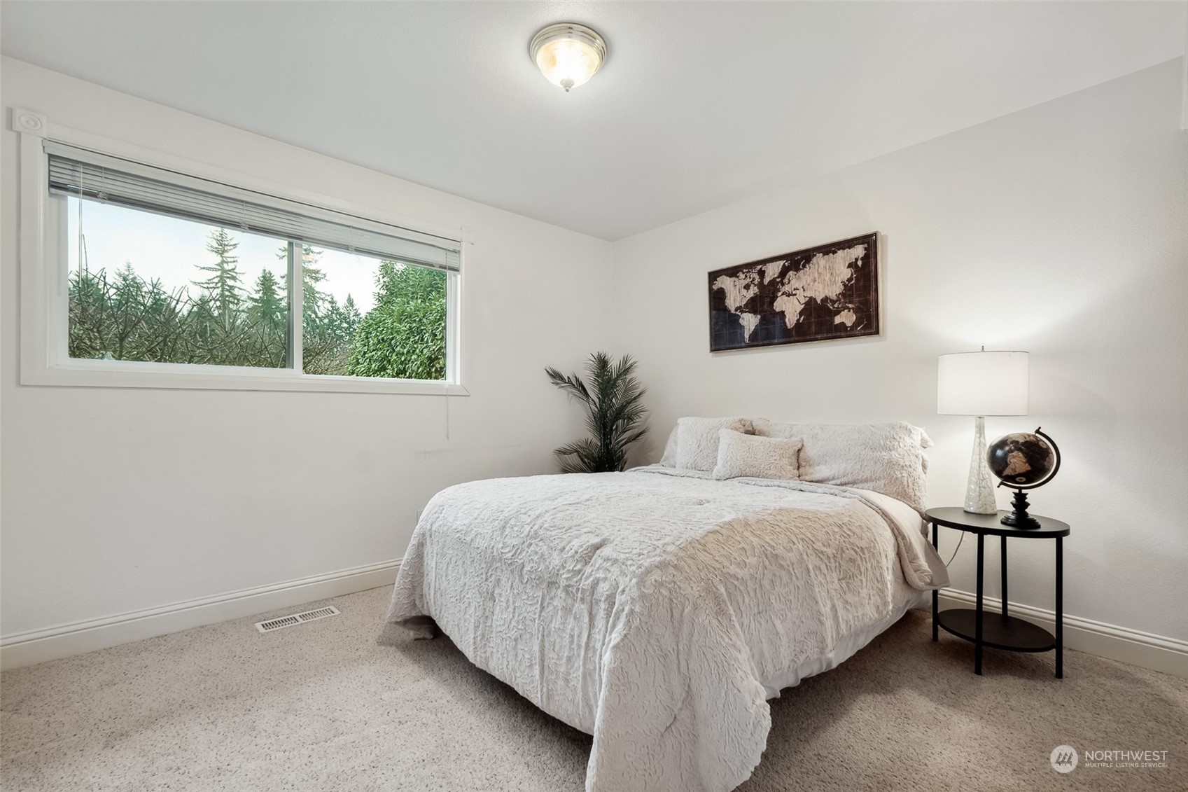 10810 Southeast 182nd Street Renton, WA 98055 - Photo 16 of 24 a bedroom with a bed and a painting on the wall