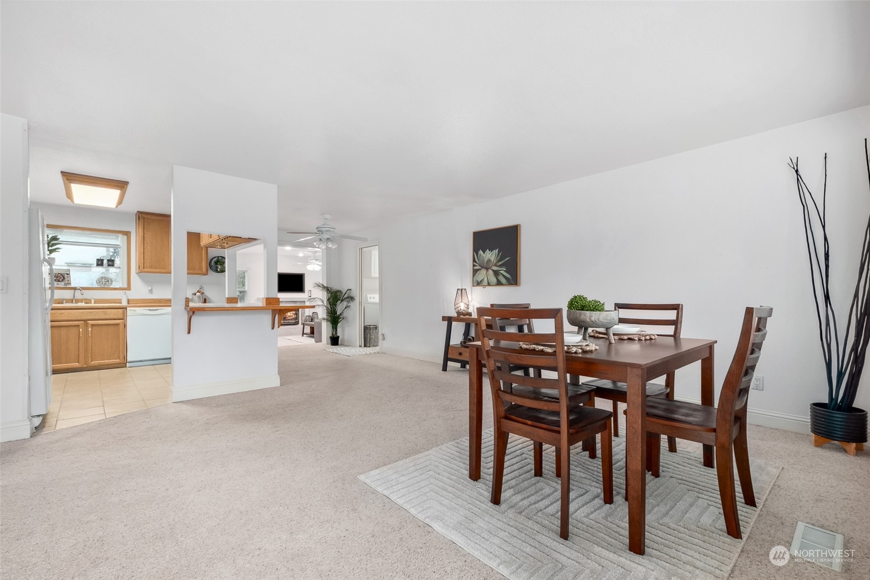 10810 Southeast 182nd Street Renton, WA 98055 - Photo 3 of 24 a view of a dining room with furniture and a livingroom