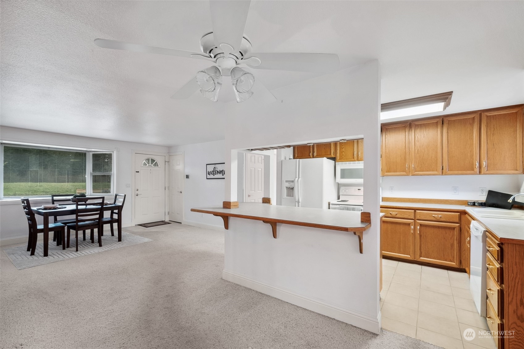 10810 Southeast 182nd Street Renton, WA 98055 - Photo 6 of 24 a open kitchen with stainless steel appliances granite countertop a sink stove and refrigerator