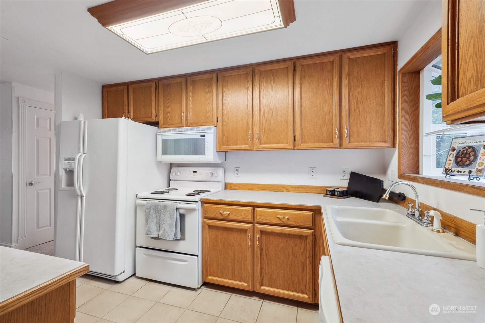 10810 Southeast 182nd Street Renton, WA 98055 - Photo 7 of 24 a kitchen with a sink cabinets and stainless steel appliances