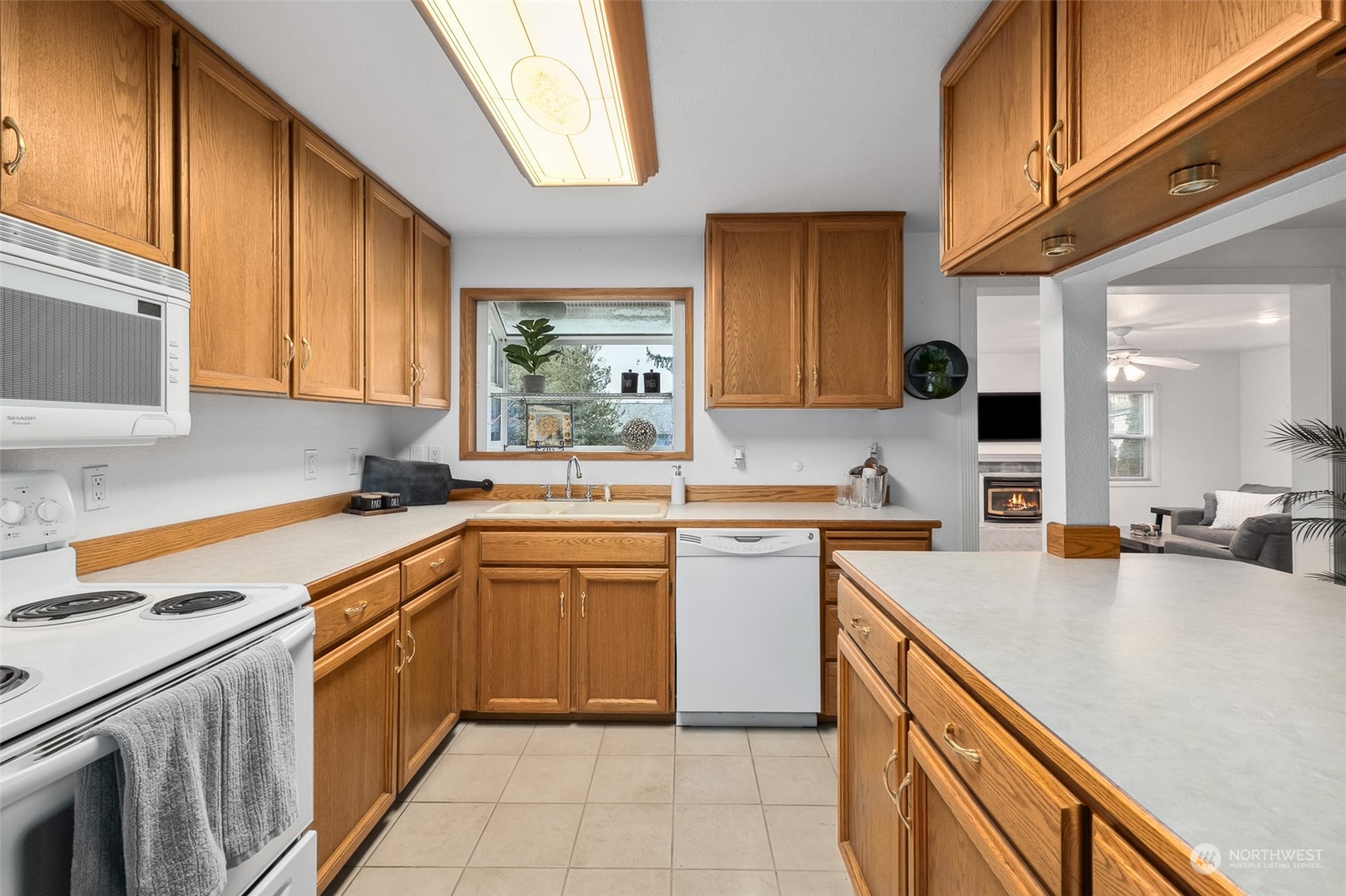 10810 Southeast 182nd Street Renton, WA 98055 - Photo 9 of 24 a kitchen with stainless steel appliances granite countertop sink stove and refrigerator