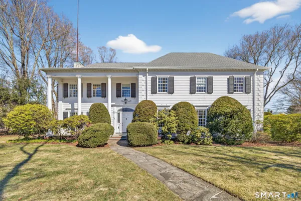 a front view of house with yard and trees around