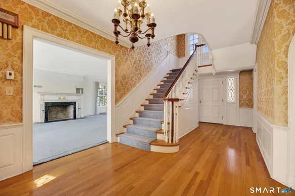 a view of entryway and hall with wooden floor