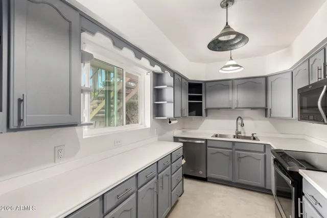 a kitchen with a sink stove and microwave