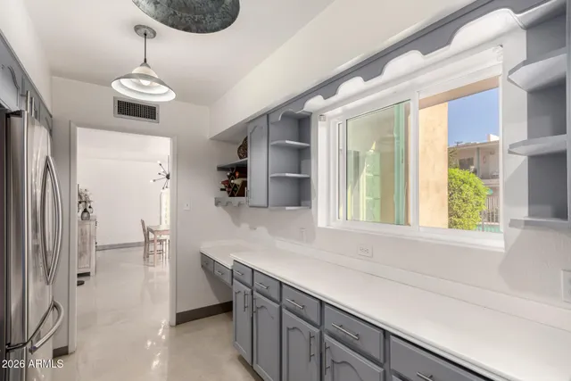a kitchen with stainless steel appliances a refrigerator sink and cabinets