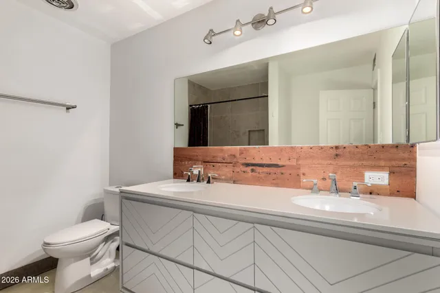 a bathroom with a sink toilet and mirror