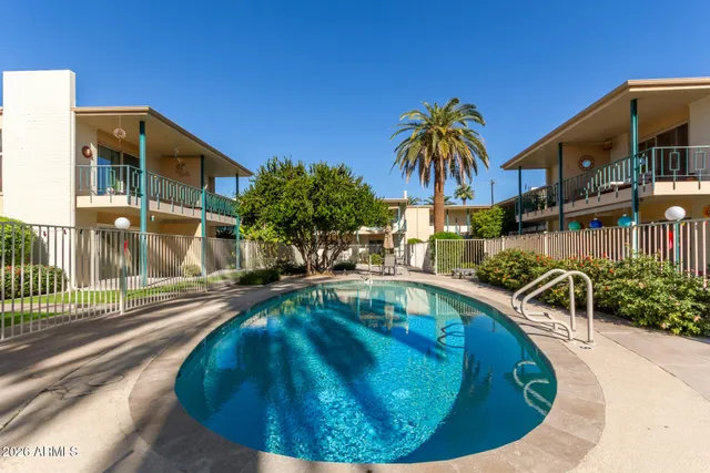 a swimming pool with outdoor seating and yard