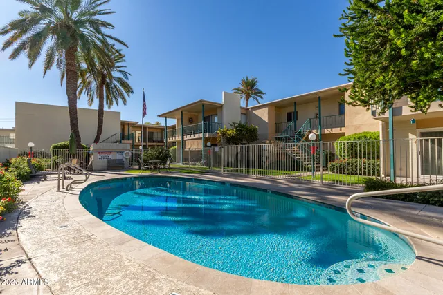 a swimming pool view with a outdoor seating